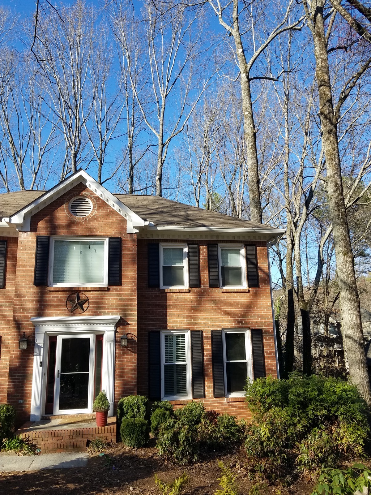 A Woodstock, GA home with large trees close to the roofline